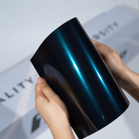 TeckWrap A5 Metallic Paint Protection Film sample showing dark teal blue shine on black base