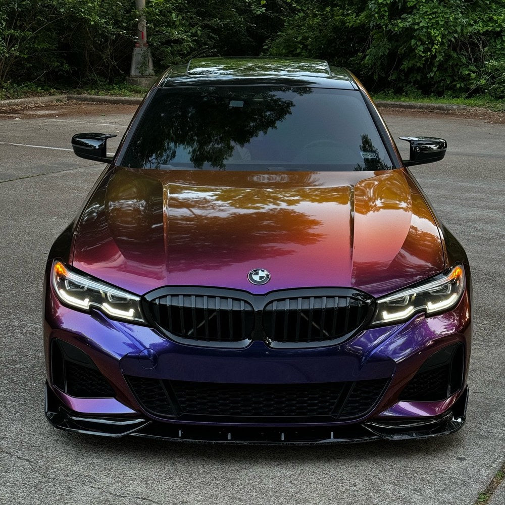 BMW 3 Series front view showing the orange-to-purple sunset gradient of TeckWrap Gloss Color Shift Chameleon Purple Sunset vinyl wrap (RD20PRO-HD)