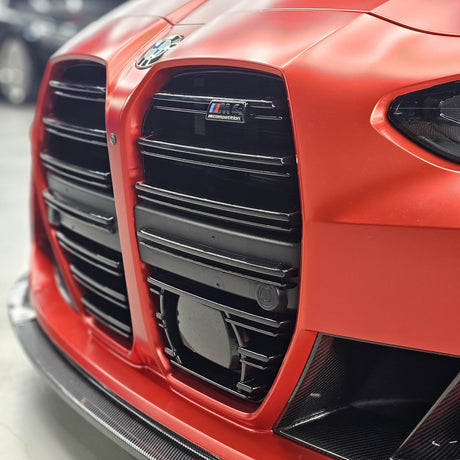 Close-up of the grille and M4 Competition badge on a TeckWrap Satin Crimson Red wrap (VCH401-S)