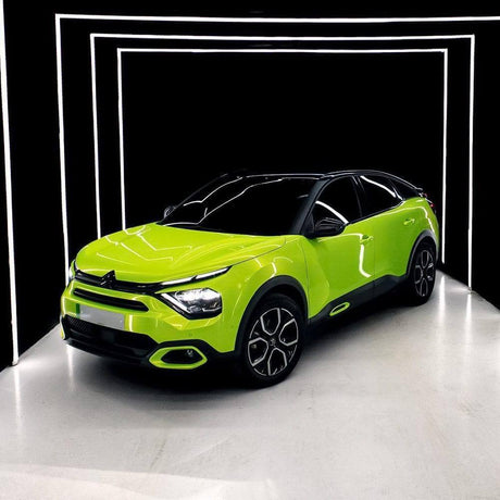 Citroën crossover wrapped with TeckWrap Gloss Acid Lime (RB07-HD) vinyl wrap, enhancing its stylish, luminous lime finish under studio lights.