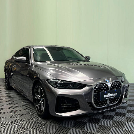 BMW sports car elegantly wrapped with TeckWrap’s Dark Platinum (RB12-HD) Vinyl in gloss, emphasizing the vehicle’s sophisticated design and luxurious metallic hue.