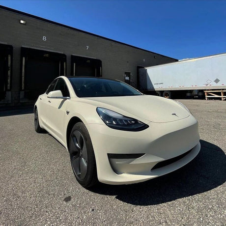 Tesla Model 3 front angle showcasing TeckWrap’s Vanilla Cream (SCM26-R) Matte Vinyl Wrap under bright sunlight
