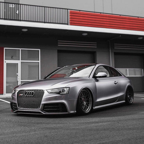 Audi sports car wrapped in TeckWrap Charcoal Grey Satin Vinyl, enhancing its sleek, aggressive stance with a modern matte finish.