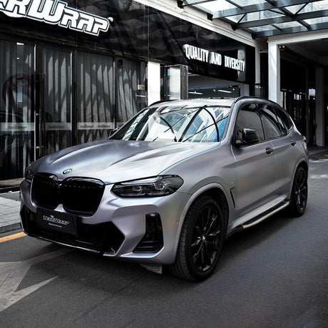Side-angle shot of BMW SUV in Charcoal Grey Satin Vinyl Wrap by TeckWrap, capturing its premium finish under natural lighting.