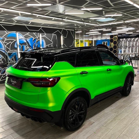 Rear three-quarter view of a vehicle with Paradise Green Satin Vinyl Wrap (SMT12), emphasizing the wrap’s seamless satin finish and dynamic green hue.