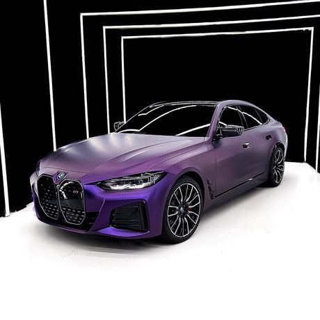 Studio front-angle view of a BMW wrapped in premium TeckWrap Satin Venetian Violet (SMT03) vinyl wrap, emphasizing the elegant satin violet color and detailed contours.